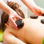 hot stones on a massage therapy customer